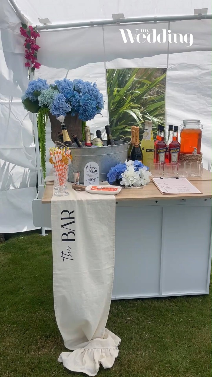 DIY Fabric Bar Sign ✨

Elegant, affordable, easy, and guaranteed to elevate your special occasion.
This only cost me $40 and a bit of time to make (plus a Cricut machine if you don’t have one — I borrowed mine).

What you’ll need:

• Table runner
• Cricut machine
• Cricut iron-on smart vinyl
• Baking paper
• Iron

How to make it:

1.) Create your “The Bar” design in Canva — have fun and put your own spin on it.
2.) Import the design into Cricut Design Space and remove the background.
3.) Load the smart vinyl into the Cricut machine and mirror the design so it doesn’t end up backwards when you iron it on.
4.) Let it print!
5.) Weed out the excess vinyl using your Cricut tools.
6.) Heat up your iron — no steam. It needs to be completely dry. There’s a handy fabric heating guide on the Cricut website.
7.) Iron the fabric first to remove wrinkles and warm the surface.
8.) Place the design on the fabric, cover with baking paper, and iron on (this takes a few minutes). The baking paper stops the plastic melting onto your fabric or iron.
9.) Slowly peel off the plastic. If the vinyl is lifting, it just needs more heat.

Once it’s fully stuck — enjoy your new bar sign! 🍸