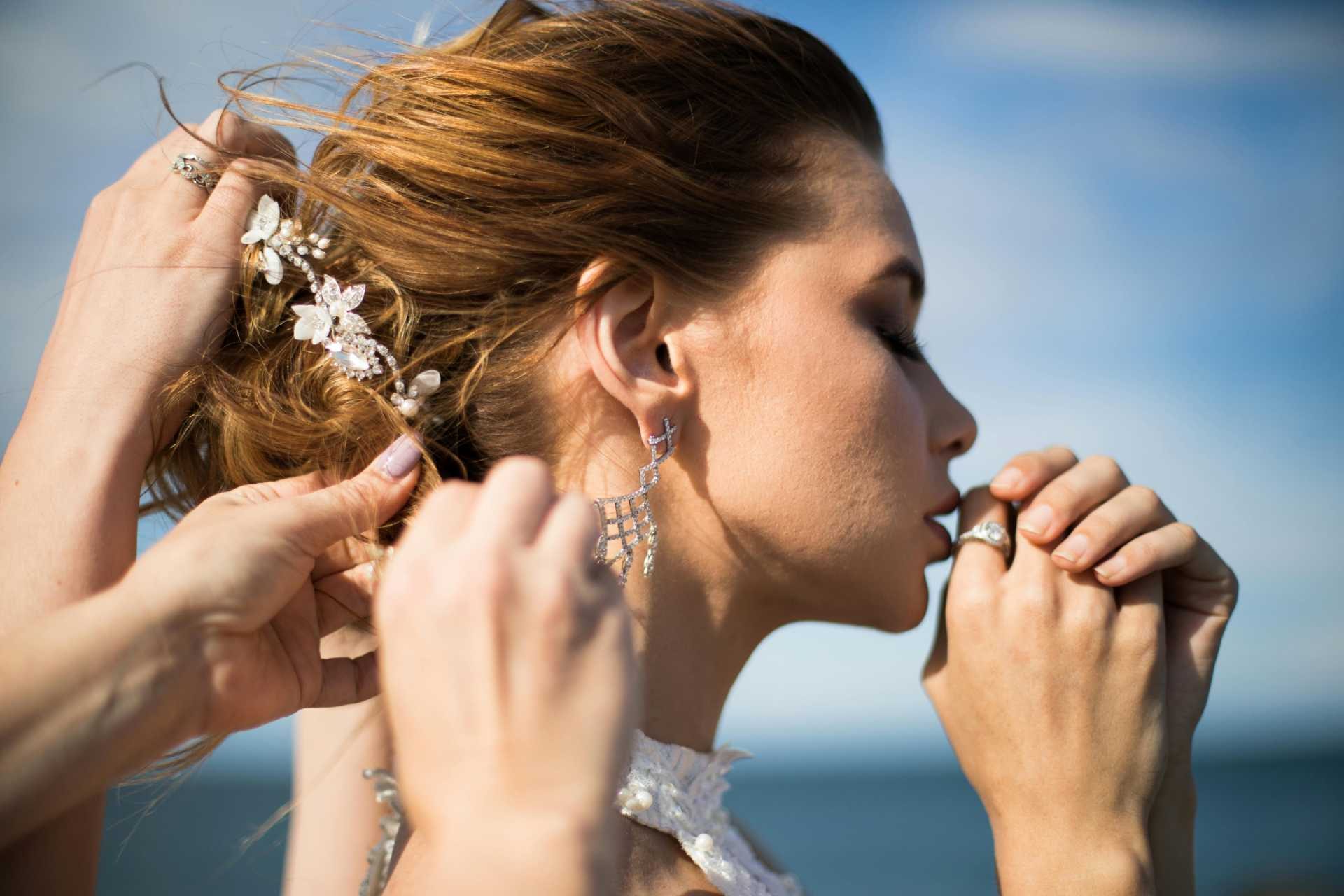 Woman outdoors getting her hair styled with a floral hair accessory