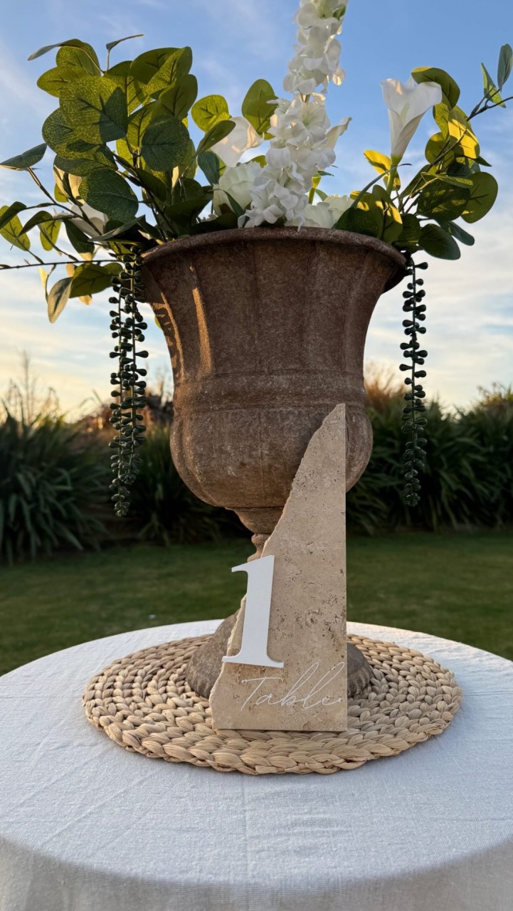 Wedding table number DIY 

Easy, fun and really cost effective. This is such a beautiful edition to the wedding tables and how fun to mention to guests that you have made that.

Shopping list: 

• Concrete paver 
• Wooden numbers 
• White paint
• Blu-Tack or Super glue 

Optional: 

• Cricut machine 
• Smart Stencil 
• Transfer Tape 

Instructions: 

• Head to your local hardware store to pick up the concrete paver and paint if you need it (we luckily had some at home).
• Swing past Spotlight for wooden numbers + Cricut supplies.
• Smash paver on the ground so it’s in bits & use a hammer to break up bits which are still too big. 
• Take an image of the paver pieces import to Canva and play with design (also try out some different colours if you wish).
• Export design from Canva into Cricut. 
• Cut out the stencil sheet to match the different sizes of paver pieces. 
• Put the Cricut machine to work to cut out design / font of “Tables” into the stencil sheet/s. 
• Paint the wooden numbers with desired colour.
• Use transfer tape to transfer the smart stencil “Table” design over to the concrete slab (make sure you have cleaned it before hand and lined up where it looks best).
• Paint over top of the stencil sheet and leave to dry. 
• Wooden numbers might need a couple of coats for desired effect. 
• Remove stencil tape and stick on your wooden number. 

Wedding ready ♥️